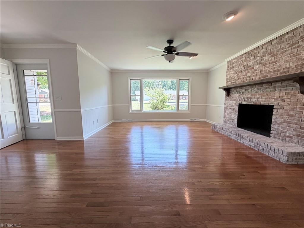Living room with brick fireplace and hardwood floors