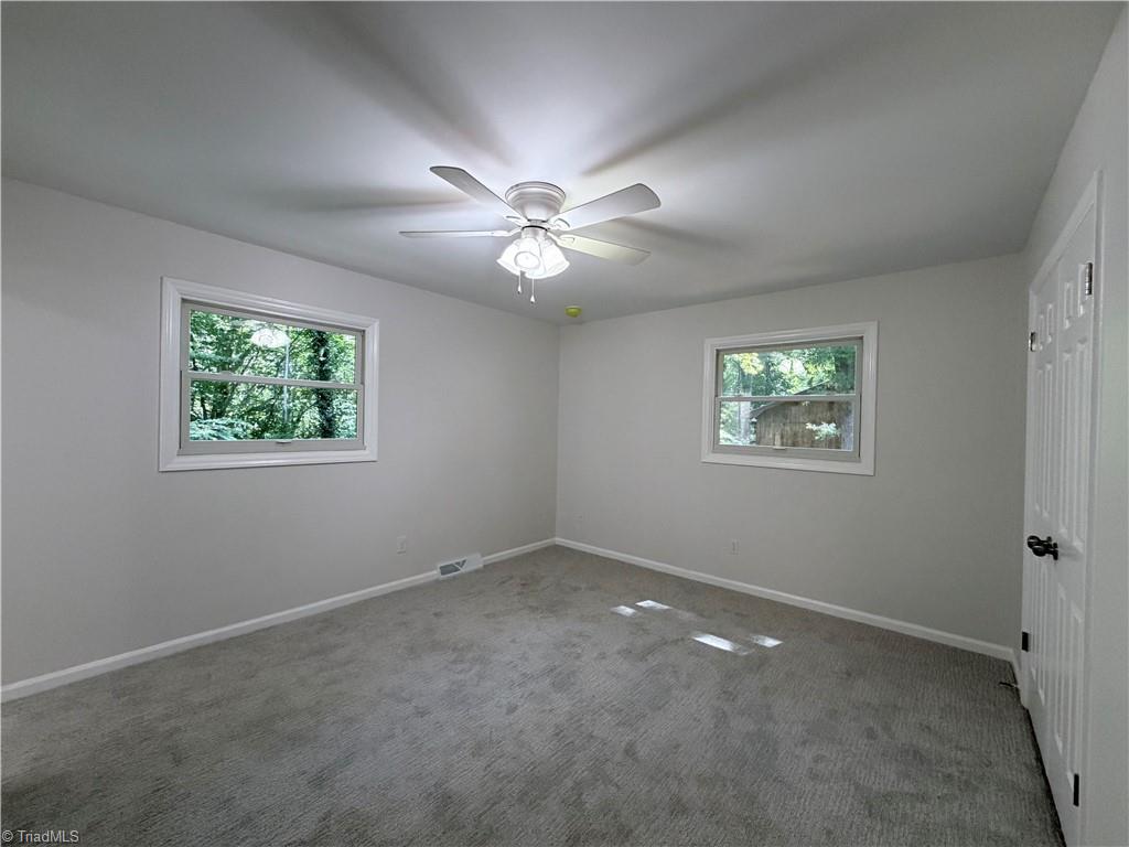 Bedroom with ceiling fan and carpet