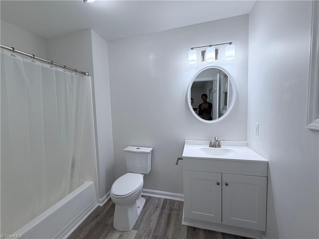 Hall bathroom with tub and vanity