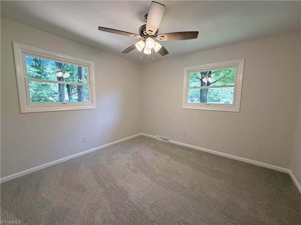 Bedroom with two windows and ceiling fan